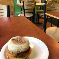 Vegan breakfast sandwich with Just Egg, “bacon,” and I added tomato and red onion. at Fancy Plants Cafe in Chicago