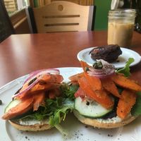 Cream cheese and smoked carrot lox bagel with chocolate donut and Breakfast Club latte w/oat milk at Fancy Plants Cafe in Chicago