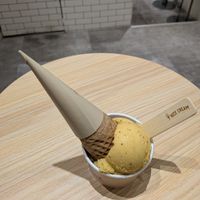 Passion fruit ice cream and oreo ice cream underneath. Cone included if you buy two scoops. at Nice Cream in Taipei