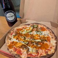 Pizza with vegan cheese, Daiya vegan sausage, artichoke, jalapeños and buffalo drizzle at Mod Pizza - 6th Ave in Seattle