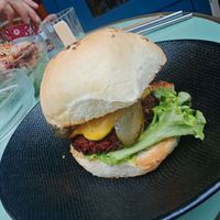 Homemade brioche bun, vegetable steak, tomato, salad, coleslaw, hot sauce and caramelized onions, served with fries.  at Primeur Cantine in Paris