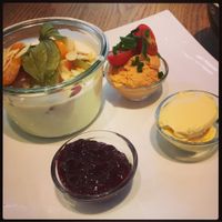 Vegan breakfast with hummus, jam, vegan butter and soyjogurt with fresh fruit. at Amalie in Speyer