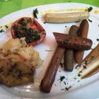 Vegan sausages with potatoes and provence tomatoes  at Espiritu Libre in Valencia
