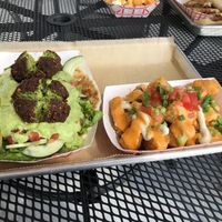 Falafel roti with loaded tots! 😍 at Curia on the Drag Food Truck in Gainesville