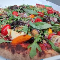 vegan pizza with a huge vegetable garnish! at Pizza Julia in Paris