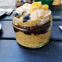 Porridge bowl with peanut butter, Mango, Açaí and blueberries at Superfood Deli - Mariahilfer in Vienna