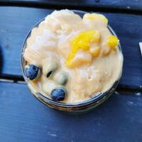 Porridge with peanut butter, Mango, blueberries, Açaí at Superfood Deli - Mariahilfer in Vienna
