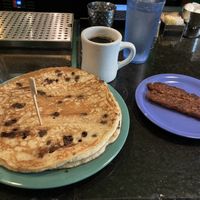 Vegan chocolate chip pancakes with vegan sausage and black coffee    at The Friendly Toast in Boston