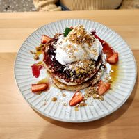 Short stack pancakes with coconut vanilla ice cream, maple syrup, and strawberries.  at Wombat Cafe & Store in Dromana