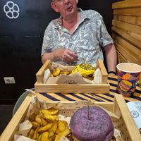 Food is presented in wooden trays. at Flower Burger in Rome