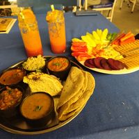 Full Vegan Thali, Orange and Strawberry juice, Hummus (awesome) with fresh Veggies ☺️ at Yummy Yoga Cafe in Udaipur