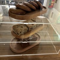 Daylight pastries: Chickpea chocolate chip cookie, Tahini cake (served with pistachio ‘ricotta’) and Upside-down caramelized banana bread at Hearth  in Amsterdam