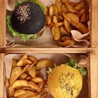black bun and cheesy burger at Flower Burger - Porta Genova in Milan