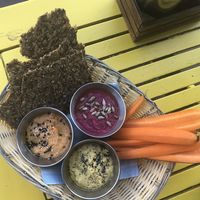Hummus Trio W Seed Bread & Carrot Spears  at Makamaka Beach Burger Cafe in Barcelona