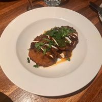 Aloo tikki (2 potato cakes) on a bed of spicy chickpeas at The Left Bank in Glasgow