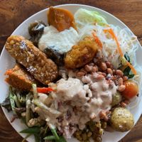 Glass noodles, tempeh, tofu, beans, sweet potatoes, peppers, potatoes, corn fritters with tahini sauce and peanuts.   at Sawobali  in Ubud