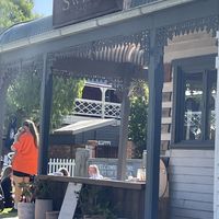 People sitting on the grass out the front of Sweet Meadow  at The Sweet Meadow in Echuca