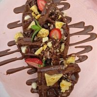 Chocolate waffles, with custard, choc sauce., honeycomb and strawberries at The Sweet Meadow in Echuca