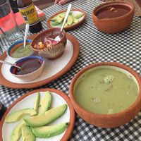 Green and red pozole with avocado  at Cabuche in Oaxaca
