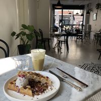 Waffles with coconut ice cream and seasonal fruit. Spicy iced tea to drink.  at Acacia in Frederiksberg