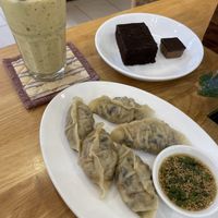 Tropical juice, best vegan gyozas ever, vegan brownie and vegan peanut butter/chocolate square  at Nourish Cafe in Yangon