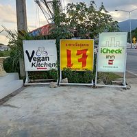 Signs on the highway outside Trams Square Wellness at Ama Vegan Kitchen in Chiang Mai