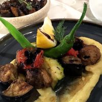 Baked mushrooms, eggplant, cherry and zucchini on a fava pillow. Part of vegan meze in Windmill, 2021. at Windmill Restaurant in Paphos