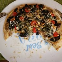 I had to dive in! A delicious vegan pizza with mushroom cream, mushroom, onion, olives, Walnuts and vegan cheese 😋 at Veggie's World in Andorra La Vella