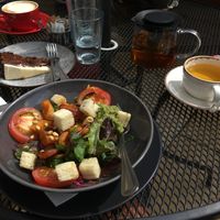 Vegan bowl with peacamole and carrot cake in the background  at Turtle Bean Cafe in Liss