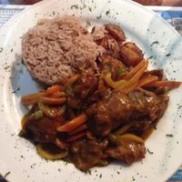 curry ";chicken"; with a side of rice and planting  at Judy's Island Grill in Glen Burnie