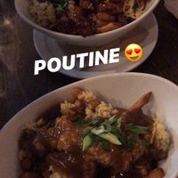 Tao poutine made vegan on top and the vegan poutine on bottom, both delicious ! at L'Gros Luxe in Quebec