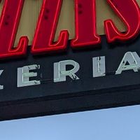 They showcase vegan options on their big sign at Razzi's Pizzeria - Howell St in Seattle