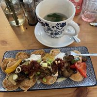 Poffies (small pancakes) with roasted vegetables, vegan cream cheese made from silken tofu, sun tomato crunch, spring onions & roasted pine nuts  at Poffers Cafe in Stuttgart