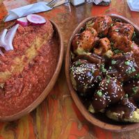 Torta Ahogada (big baguette sandwich with mushrooms covered in salsa) and Alitas Coliflor Capeadas (aka. “cauliflower wings”).  at La Flaca - Americana in Guadalajara