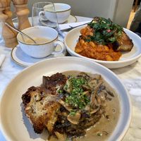 Creamy truffle mushrooms on pan-fried garlicky sourdough & Harissa and garlic butterbeans with garlic and chilli sautéed rainbow chard on pan-fried garlicky sourdough.  Amazing.  at Plants by Deliciously Ella in London