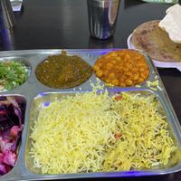 Yoghurt, spinach potato curry, channa masala, half and half biriyani and saffron rice, salad  at HealthyWealthy in North London