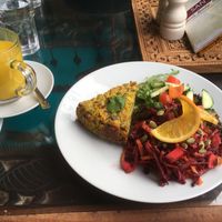 Vegan quiche, superfoods salad, hot coconut milk with tumeric. at Santosa Wellness Centre Cafe in Edinburgh