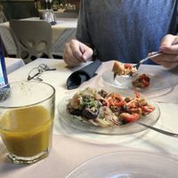 Panzanella and eggplant with onions starter and the “yellow” juice pineapple with turmeric, so good.  at La Tecia Vegana in Venice