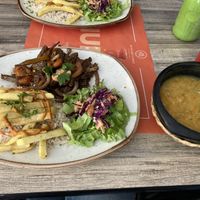 Seitan dish with soup and iced tea  at Mestizo Vegano in Bogota