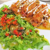 A base of platano with a delicious topping. The salad was really tasty too! at Mestizo Vegano in Bogota