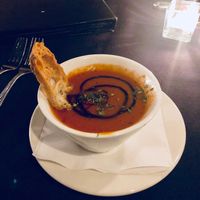 Yummy tomato red pepper bisque. I didn’t eat the bread I’d ask if it’s vegan!  at River City Grill in Yuma