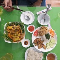 Crackers, turmeric noodles, green iced tea, broken rice with marinated tofu at Zen in Ho Chi Minh City