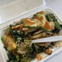 quinoa bowl with kale and broccoli. i added avocado and tofu and put the frank’s on myself    at Greens and Grains in Northfield