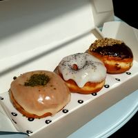 Three different vegan flavours: Vanilla and pistachio, lemon and poppeyseed, and Ferrero Rocher. at The Rolling Donut - Bachelors Walk in Dublin