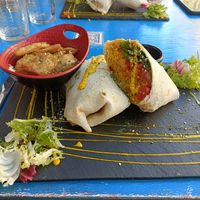 Wrap de cous cous, calabaza asada, tomate, espinacas, heura y salsa de kimchi picante at Sanissimo - Principe Pio in Madrid