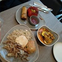 Mix; deep fried mushrooms, fried rice, hummus, sausage roll, filled pepper, spring roll and curry with tofu. at Nordvegan in Oslo
