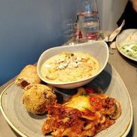 Curry, lasagna and "quick bites" sausage roll and a rice ball at Nordvegan in Oslo