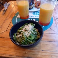 Basil pesto pasta and agua del día at Aura Vegana in Mexico City