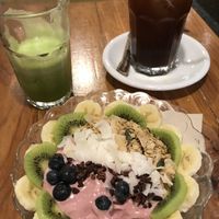 Coco breakfast bowl, detox juice and an iced americano  at Itacate in Barcelona