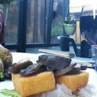 Fried polenta with caramelized mushrooms and marinated cabbage + rice & vegetables croquettes (piadina in the back not visible, sorry) at Un'Altra Idea in Bologna